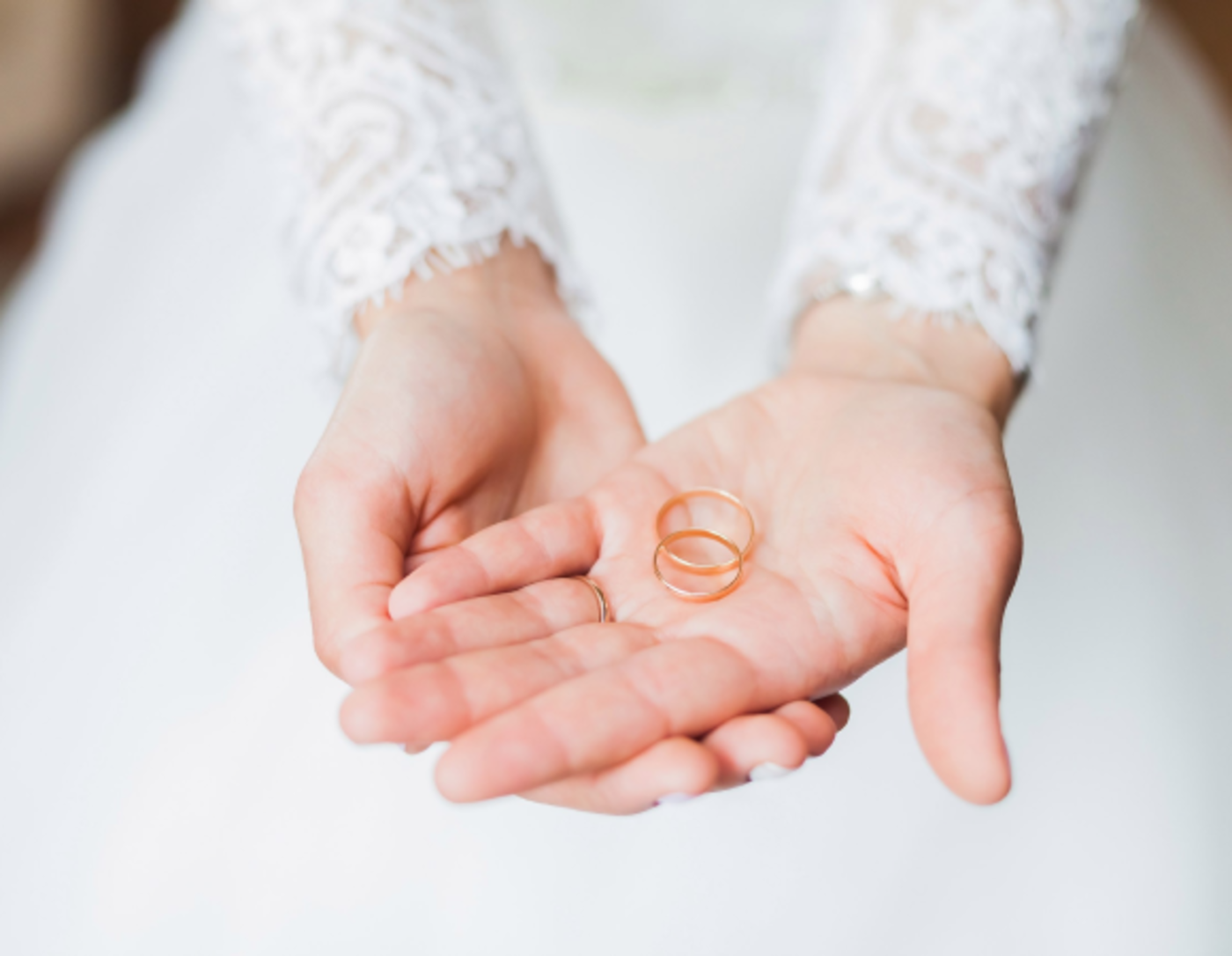 Bride holding wedding bands